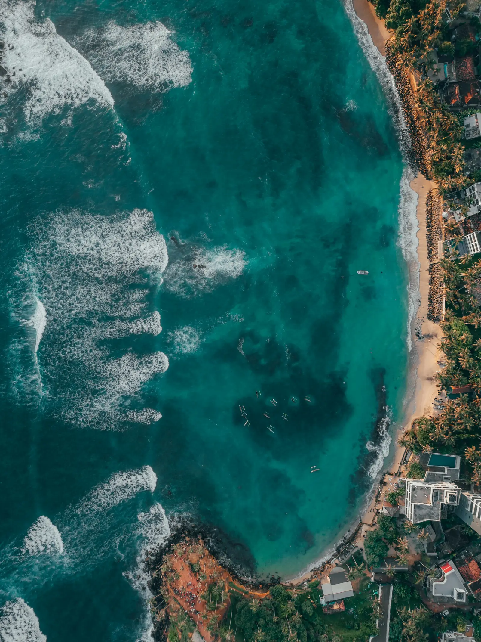 Aerial view of a turquoise bay and beach at Unawatuna, near Galle, southern Sri Lanka