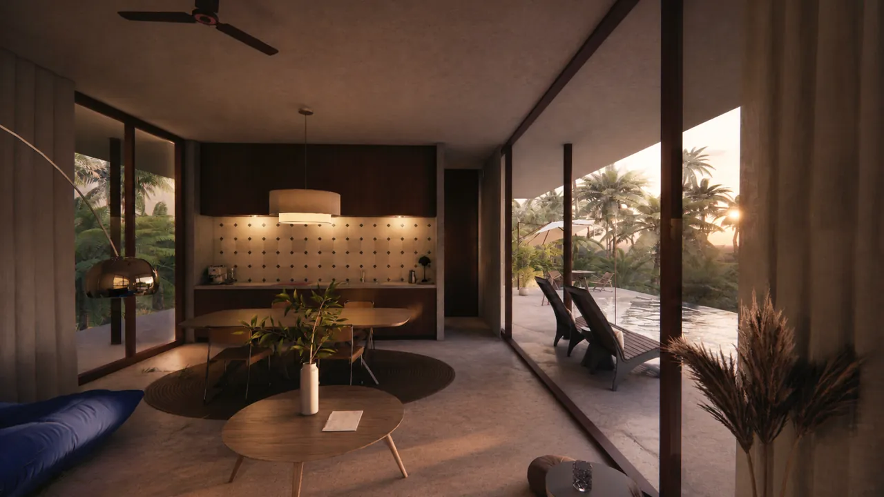 Salon ouvert de la villa 1 chambre au coucher du soleil, baies vitrées sur la piscine et le jardin tropical
